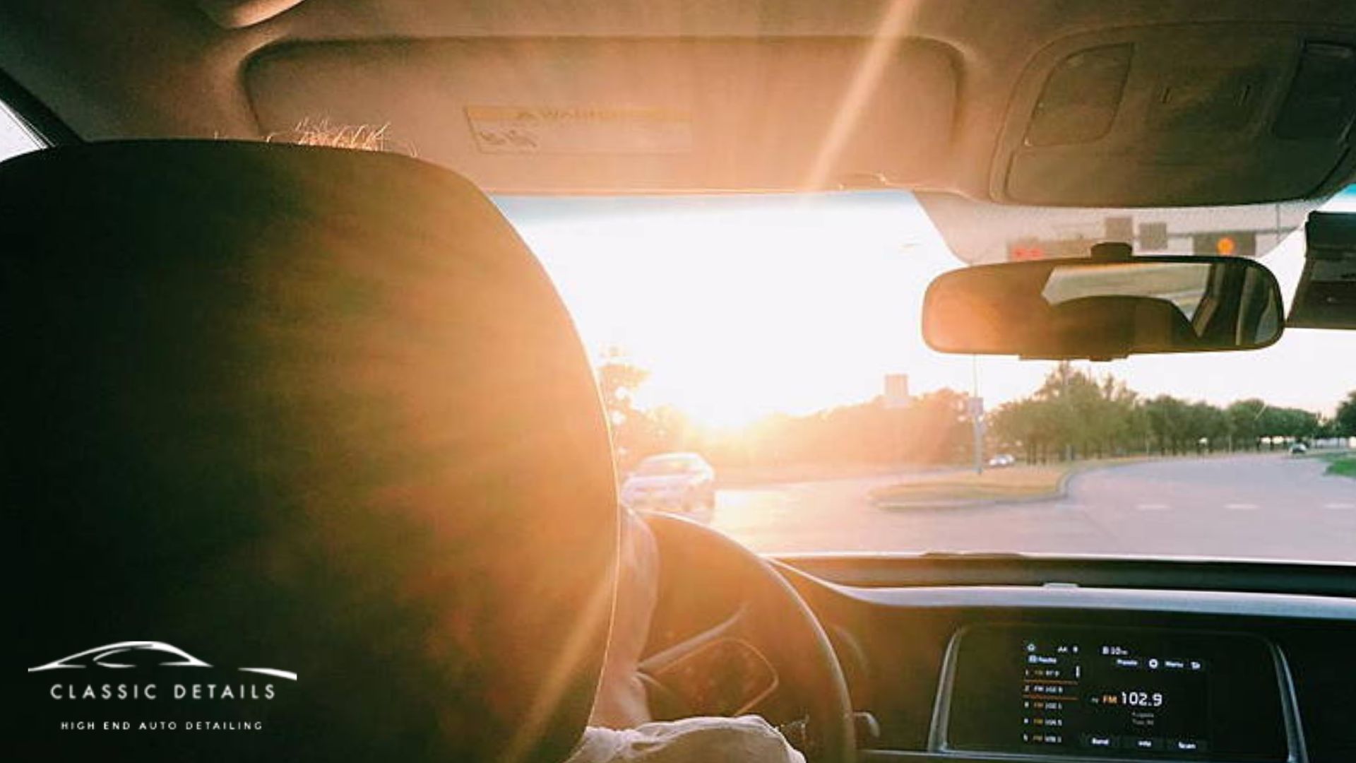 Bright Florida sun shines through a car windshield from the driver’s view. The corner logo reads "Classic Details High End Auto Detailing."